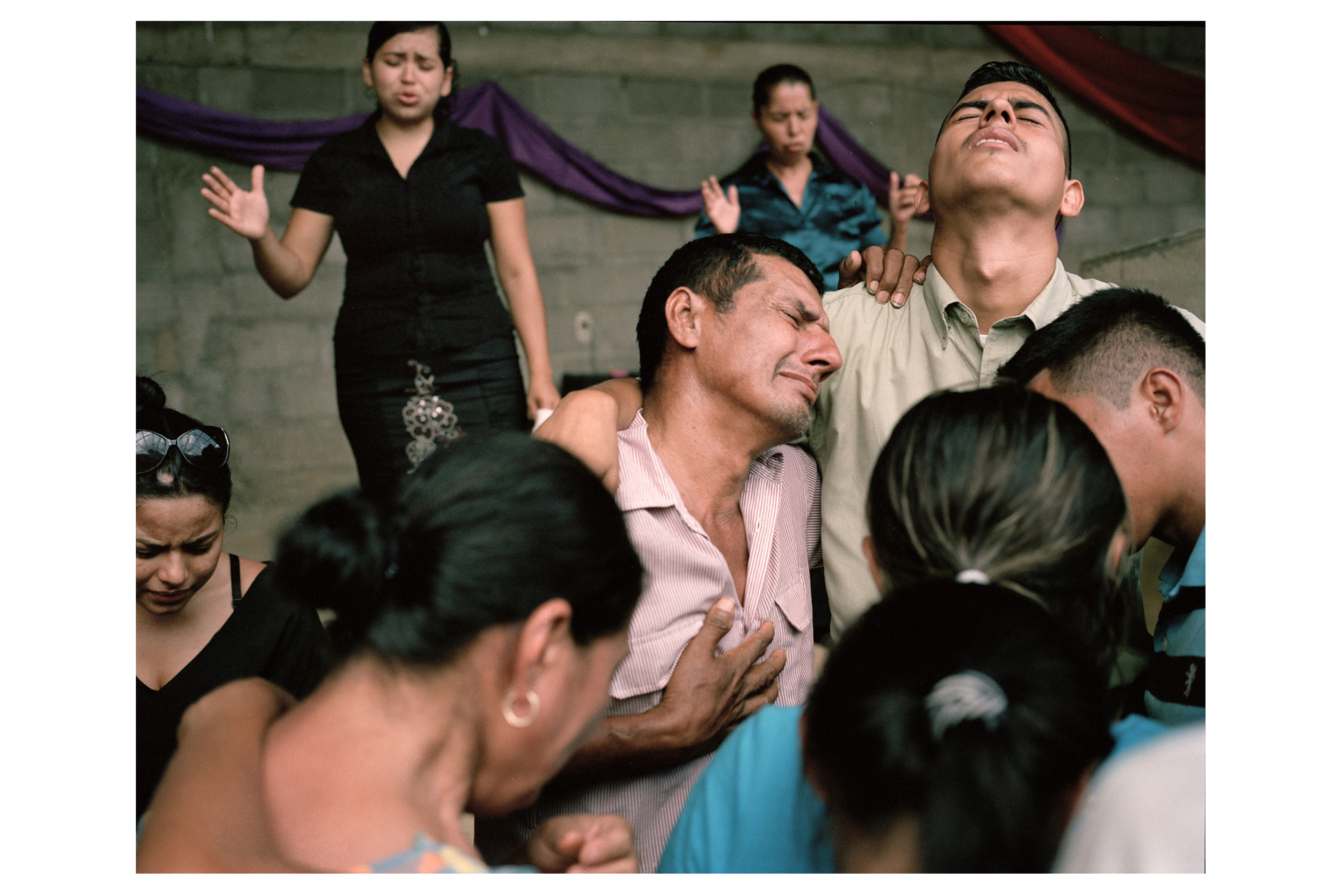 A local pastor and congregants comfort Darwin Franco’s family at a funeral in Correderos. Image by Dominic Bracco II. Honduras, 2013. Media file: website_canvas_honduras10.jpg
