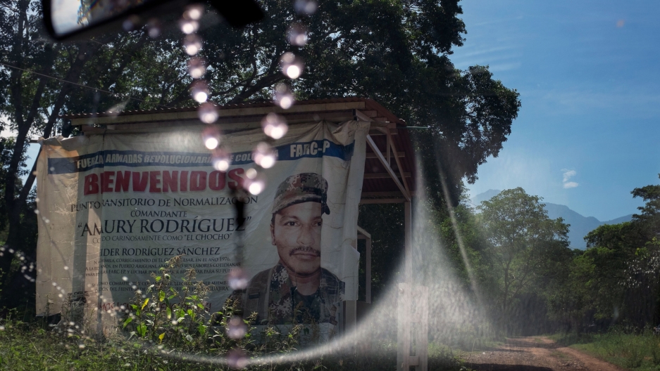 Ex-fighter Elisa Castro stands in an entrance of the FARC's memory museum at the Pondores reintegration camp in La Guajira, Colombia. Image by Fabio Cuttica/The World. Colombia, 2018. Ex-fighter Elisa Castro stands in an entrance of the FARC's memory museum at the Pondores reintegration camp in La Guajira, Colombia. Image by Fabio Cuttica/The World. Colombia, 2018.