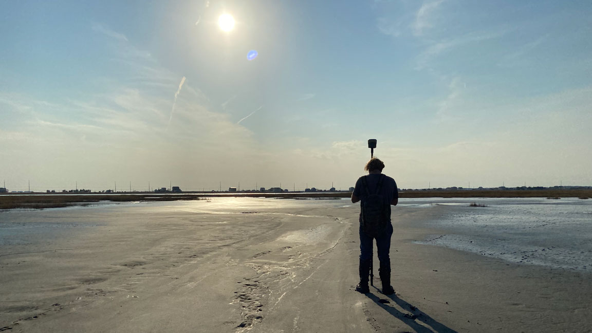 A scientist from the Army Corps of Engineers measures the elevation of newly placed dredge material on Gull Island, located within the Intracoastal Waterway off Stone Harbor in Cape May County. Image courtesy of the Wetlands Institute. A scientist from the Army Corps of Engineers measures the elevation of newly placed dredge material on Gull Island, located within the Intracoastal Waterway off Stone Harbor in Cape May County. Image courtesy of the Wetlands Institute.