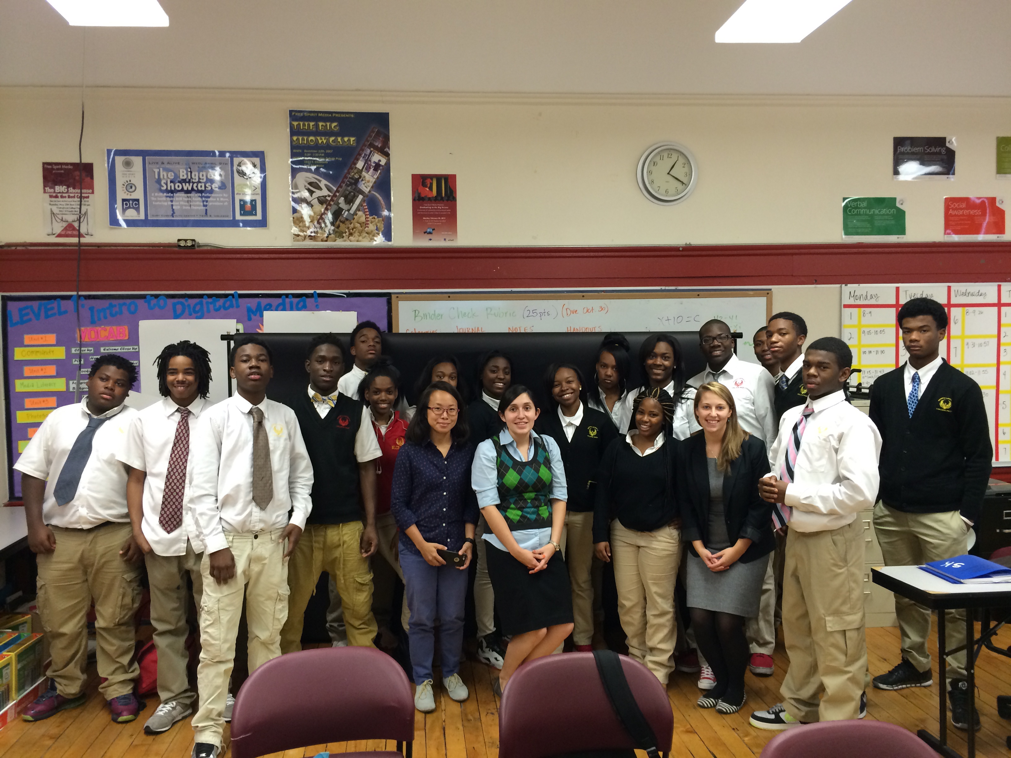Pulitzer Center grantee Sim Chi Yin poses with educators and students at North Lawndale College Preparatory Charter High School. Image by Amanda Ottaway. Chicago, 2014. Media file: img_5460.jpg