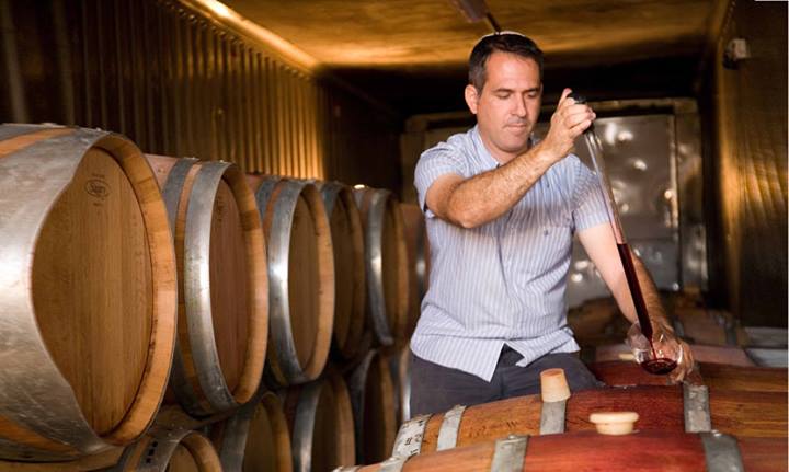 Winemaker Shivi Drori tests a sample of wine from a cask at the Gvaot Boutique Winery in the West Bank. Image courtesy of Gvaot Boutique Winery. Media file: 1235028_241082939383887_1424755423_n.jpg