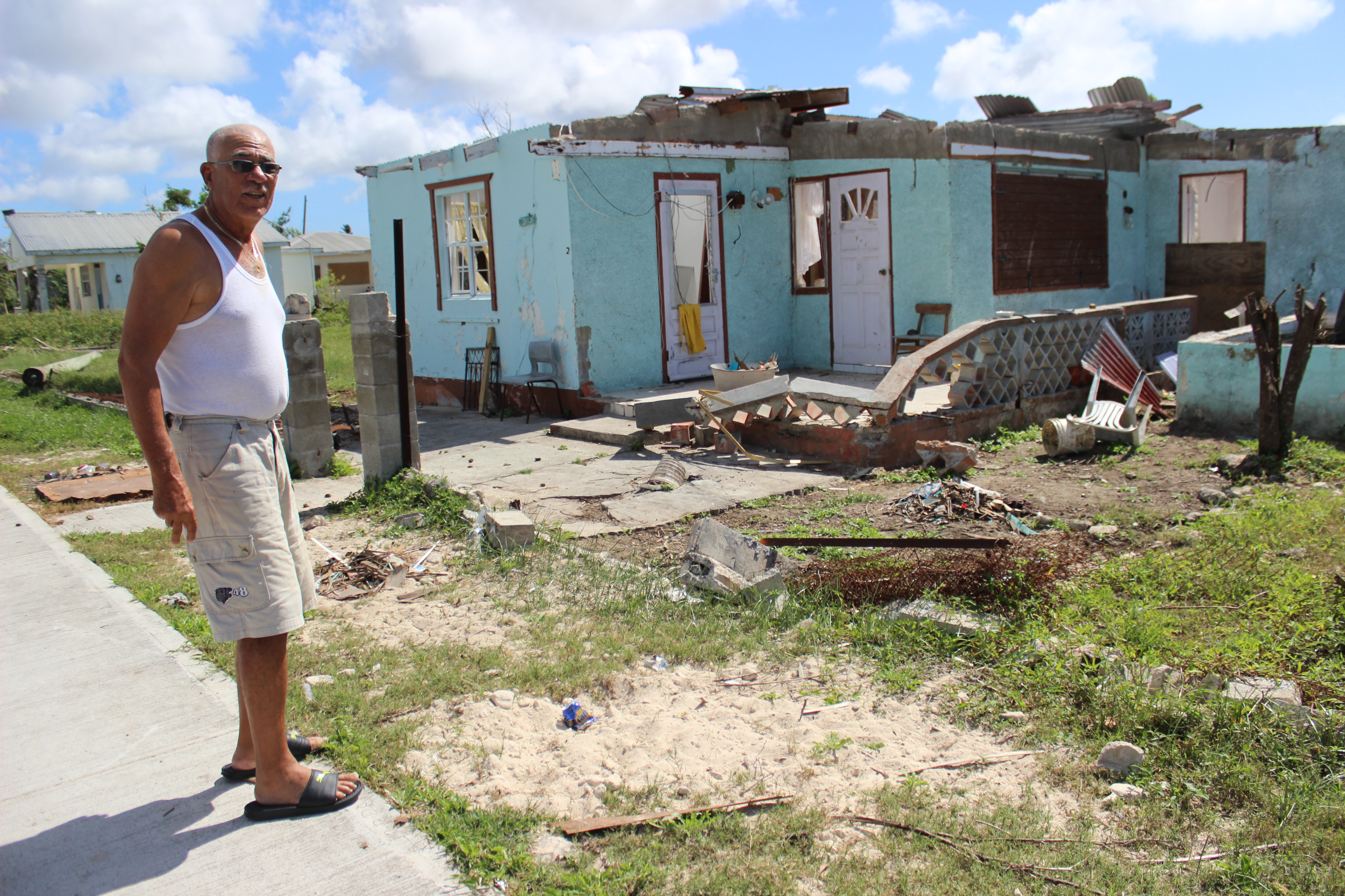 Cliff Drinkwater, a 73-year-old pensioner, surveys the damage to his childhood home in Barbuda's capital Codrington November 17, 2017. An estimated 90 percent of properties were damaged in Barbuda when the Caribbean island was hit by Hurricane Irma on Sept, 6, 2017. Image by Gregory Scruggs. Barbuda, 2017. Cliff Drinkwater, a 73-year-old pensioner, surveys the damage to his childhood home in Barbuda's capital Codrington November 17, 2017. An estimated 90 percent of properties were damaged in Barbuda when the Caribbean island was hit by Hurricane Irma on Sept, 6, 2017. Image by Gregory Scruggs. Barbuda, 2017.
