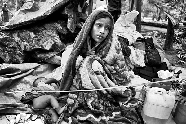 Dilara, 22, and her infant arrived in Bangladesh on September 9, 2017. She had been suffering from a high fever for more than ten days. Image by Greg Constantine for the US Holocaust Memorial Museum. Bangladesh, 2017. Dilara, 22, and her infant arrived in Bangladesh on September 9, 2017. She had been suffering from a high fever for more than ten days. Image by Greg Constantine for the US Holocaust Memorial Museum. Bangladesh, 2017.