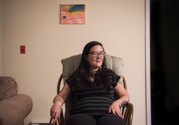 Erin Saunders, 35, at her apartment in the military base town of Happy Valley-Goose Bay, Labrador. Saunders was arrested protesting the construction of a local Canadian hydropower dam, which she says threatens her way of life. Image by Michael G. Seamans. Canada, 2019. Erin Saunders, 35, at her apartment in the military base town of Happy Valley-Goose Bay, Labrador. Saunders was arrested protesting the construction of a local Canadian hydropower dam, which she says threatens her way of life. Image by Michael G. Seamans. Canada, 2019.