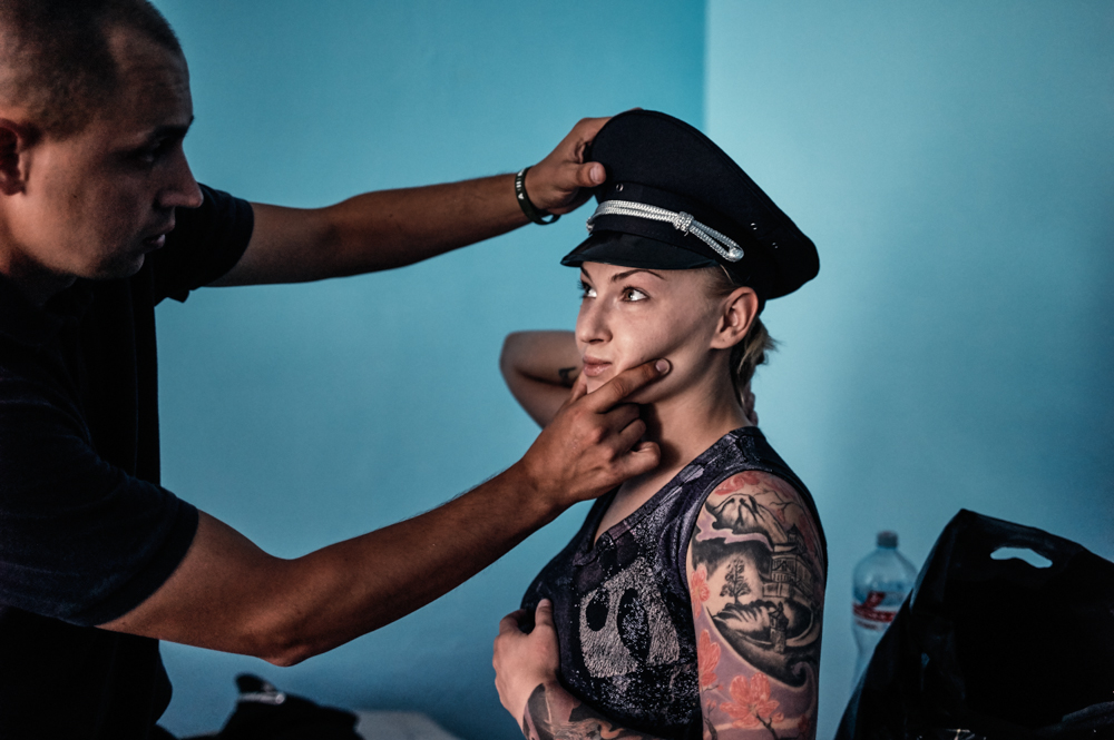 Evgeny Mamushkin checked the American-issued uniform of a new cadet, Anna Ierygina, a day before her graduation from the police academy in Kiev. Image by Misha Friedman. Ukraine, 2015.