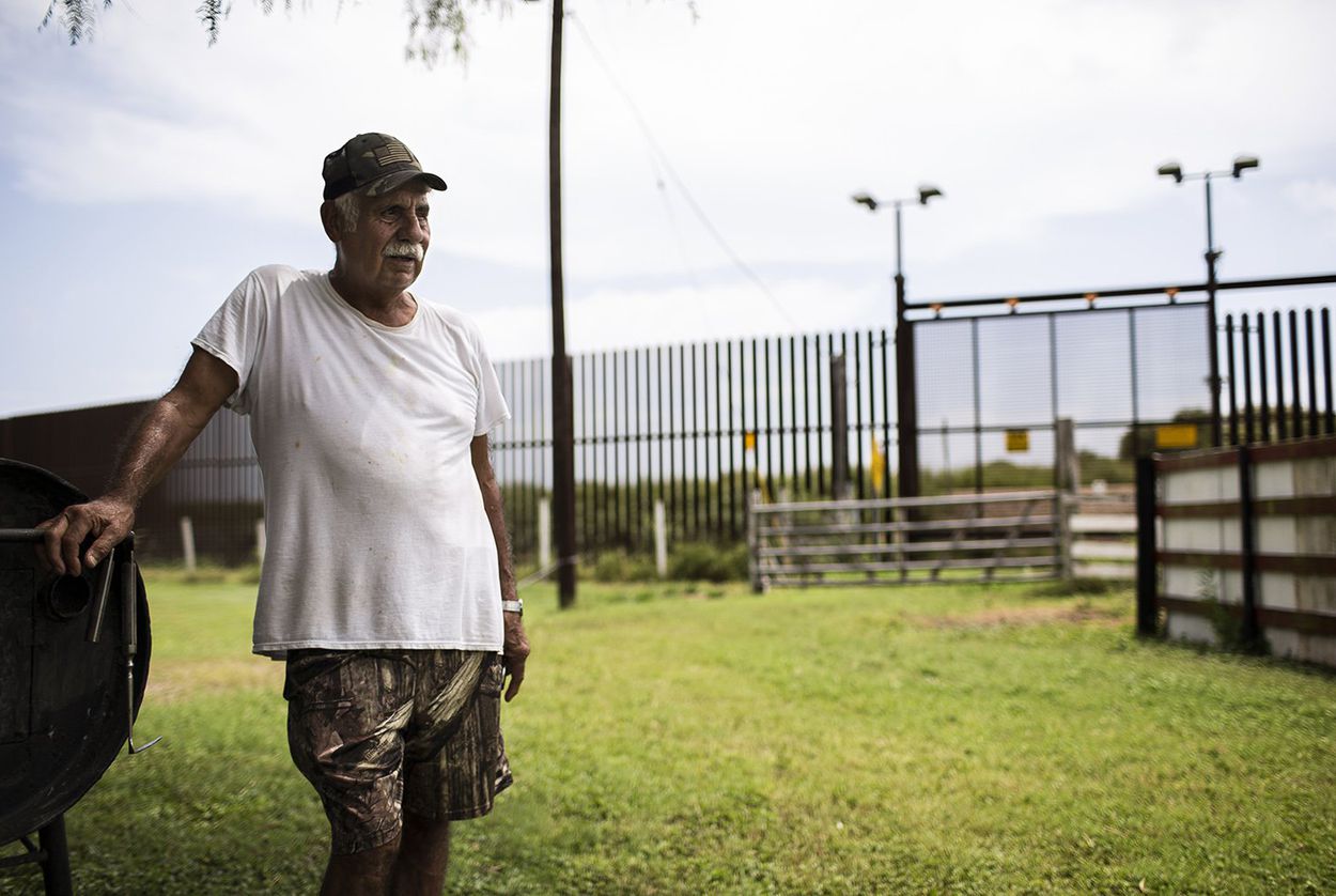Juan Cavazos at his home on Oklahoma Avenue in Brownsville, Texas. The federal government took part of the former teacher's land to build the border fence. Image by Martin do Nascimento. United States, 2017. Juan Cavazos at his home on Oklahoma Avenue in Brownsville, Texas. The federal government took part of the former teacher's land to build the border fence. Image by Martin do Nascimento. United States, 2017.