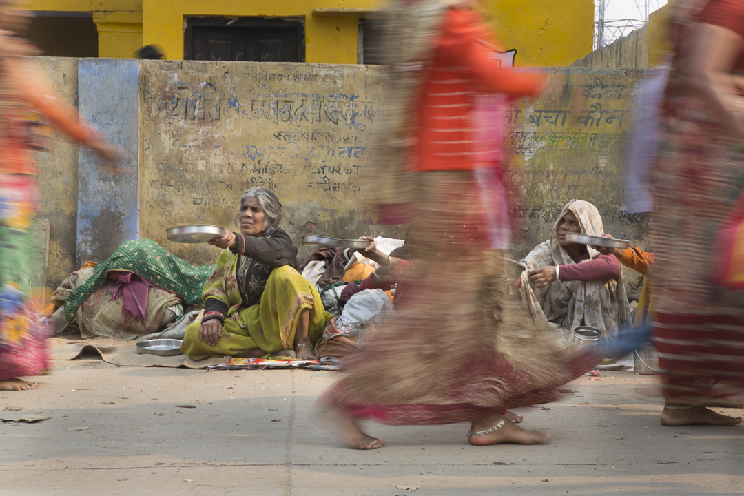 Widows beg along a pilgrimage route in Govardhan, India. Devout Hindus from all over India come here to pay homage to the sacred mountain, Govardhan Hill. Many pilgrims walk barefoot and some crawl the 21km route. Image by Amy Toensing. India, 2013. Media file: toensing_20131112_03617.jpg