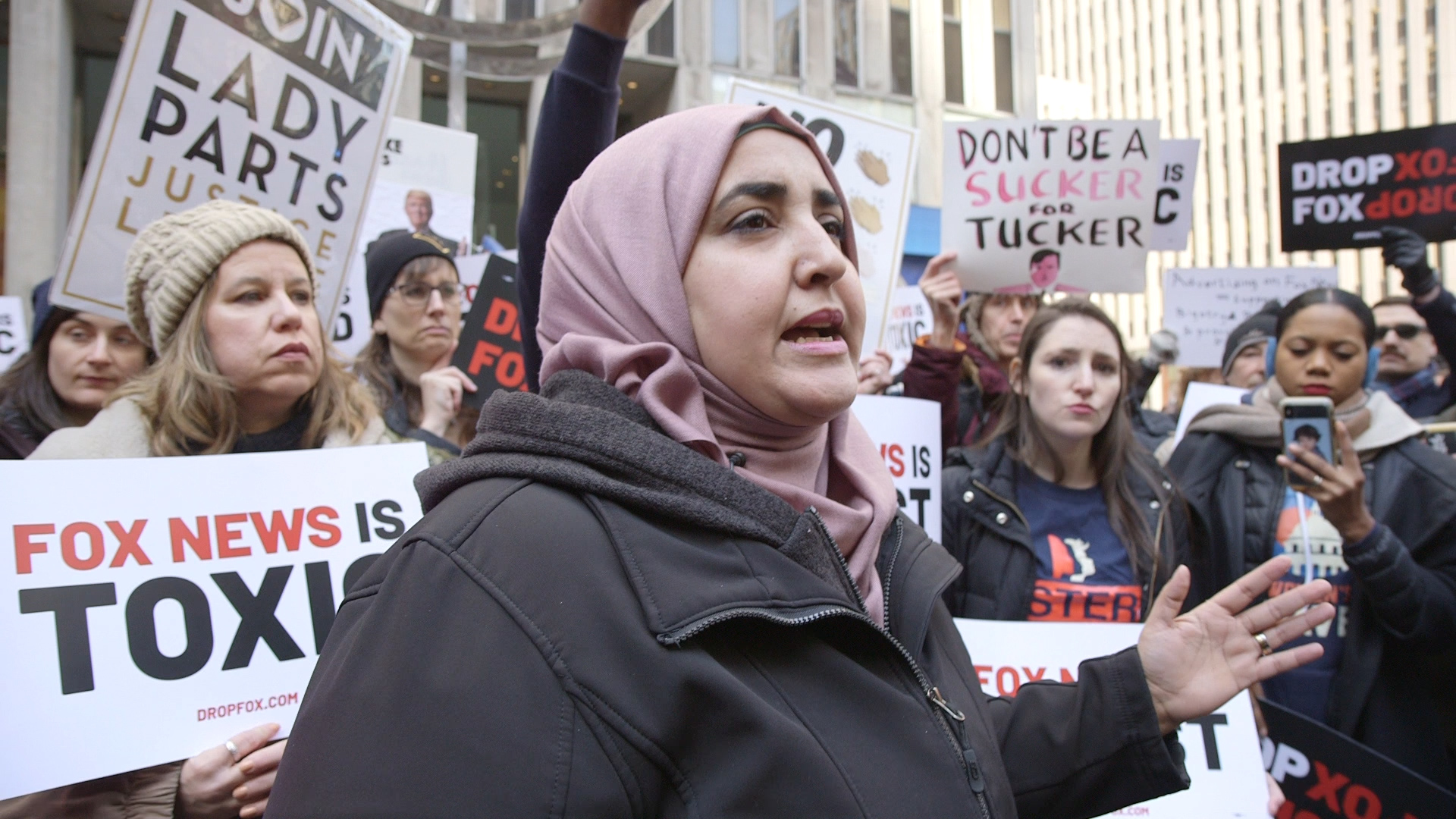 Somia Elrowmeim speaking at a protest in front of Fox News Headquarters