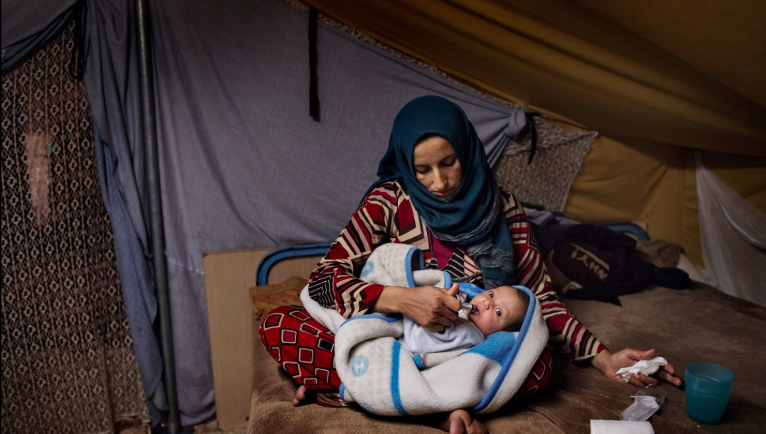 Illham holds her seven week-old baby Faraj in her tent on Nov. 20. Image by Lynsey Addario for TIME. Greece, 2016. Illham holds her seven week-old baby Faraj in her tent on Nov. 20. Image by Lynsey Addario for TIME. Greece, 2016.