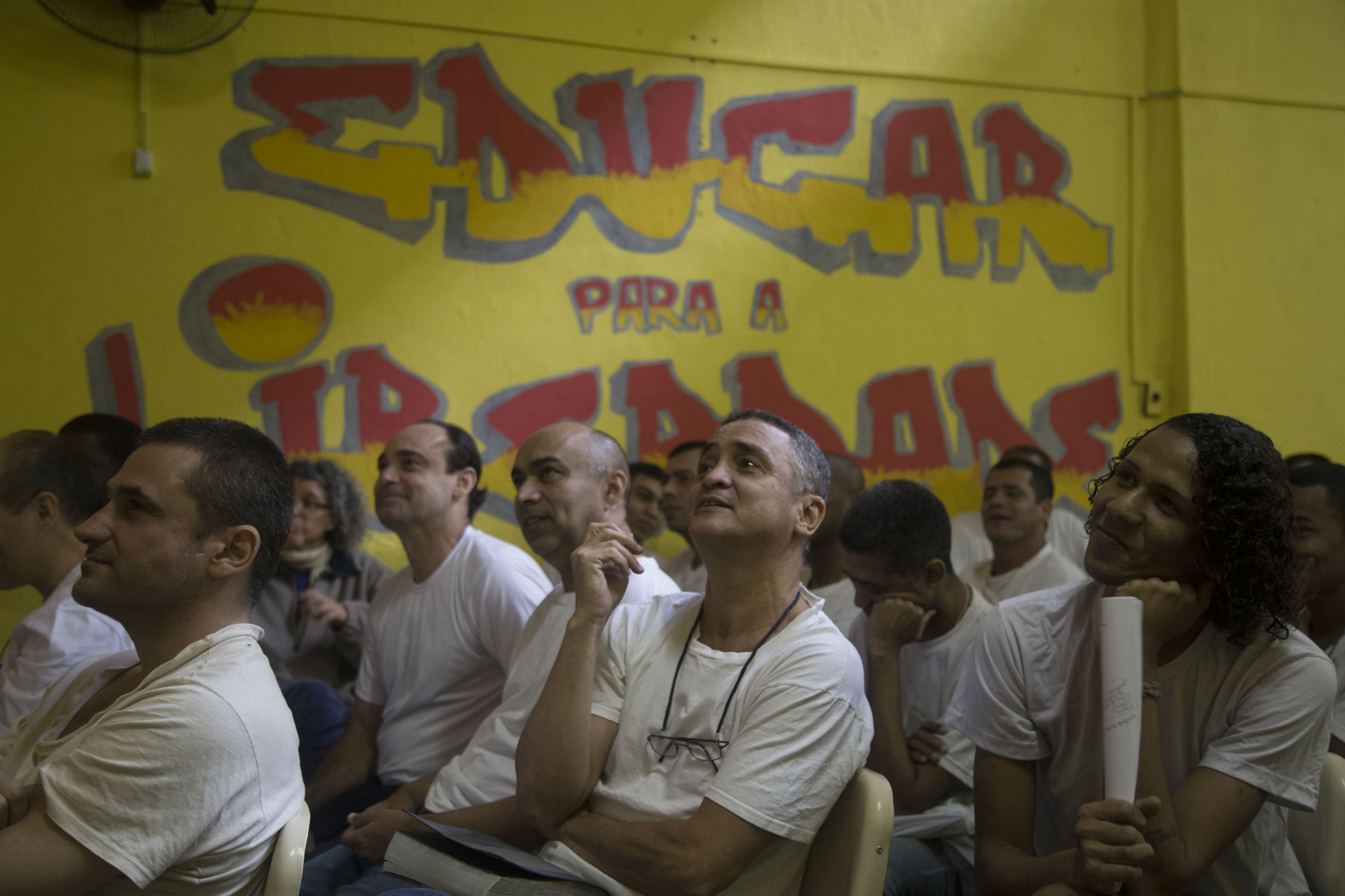 Men in the Evarisio se Moraes watch a theater performance during one of the fine arts workshops. Image by Levi Stroud. Brazil, 2016. Media file: prison1.jpg