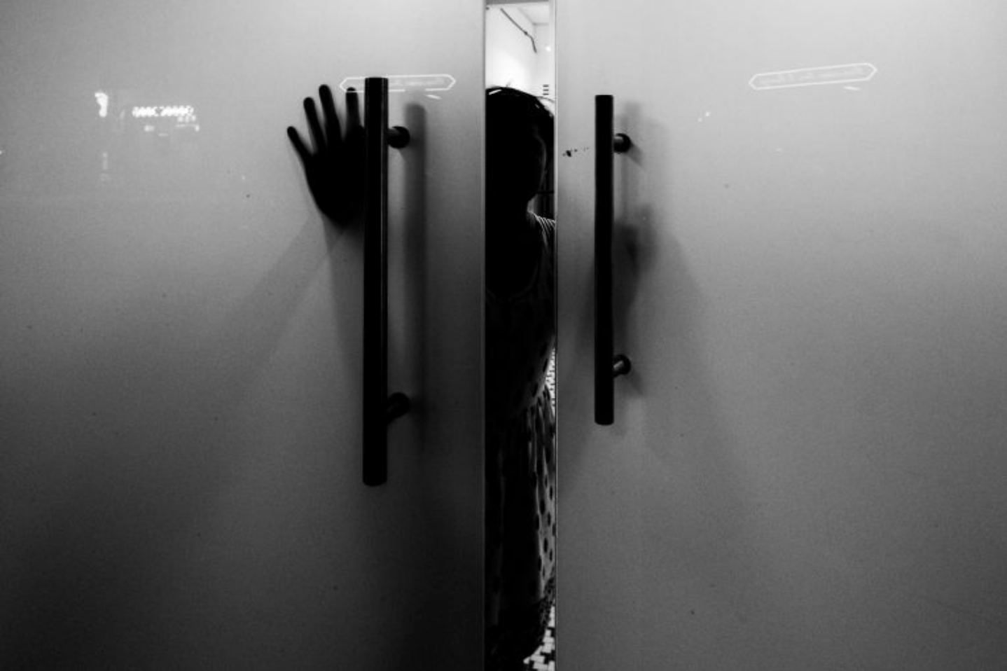 A child labor victim from Myanmar closing the door of a shelter in Singapore for migrant workers who have run away from their employers. The address of the shelter is hidden from the public for the safety. Image by Xyza Bacani. Singapore, 2016. A child labor victim from Myanmar closing the door of a shelter in Singapore for migrant workers who have run away from their employers. The address of the shelter is hidden from the public for the safety. Image by Xyza Bacani. Singapore, 2016.