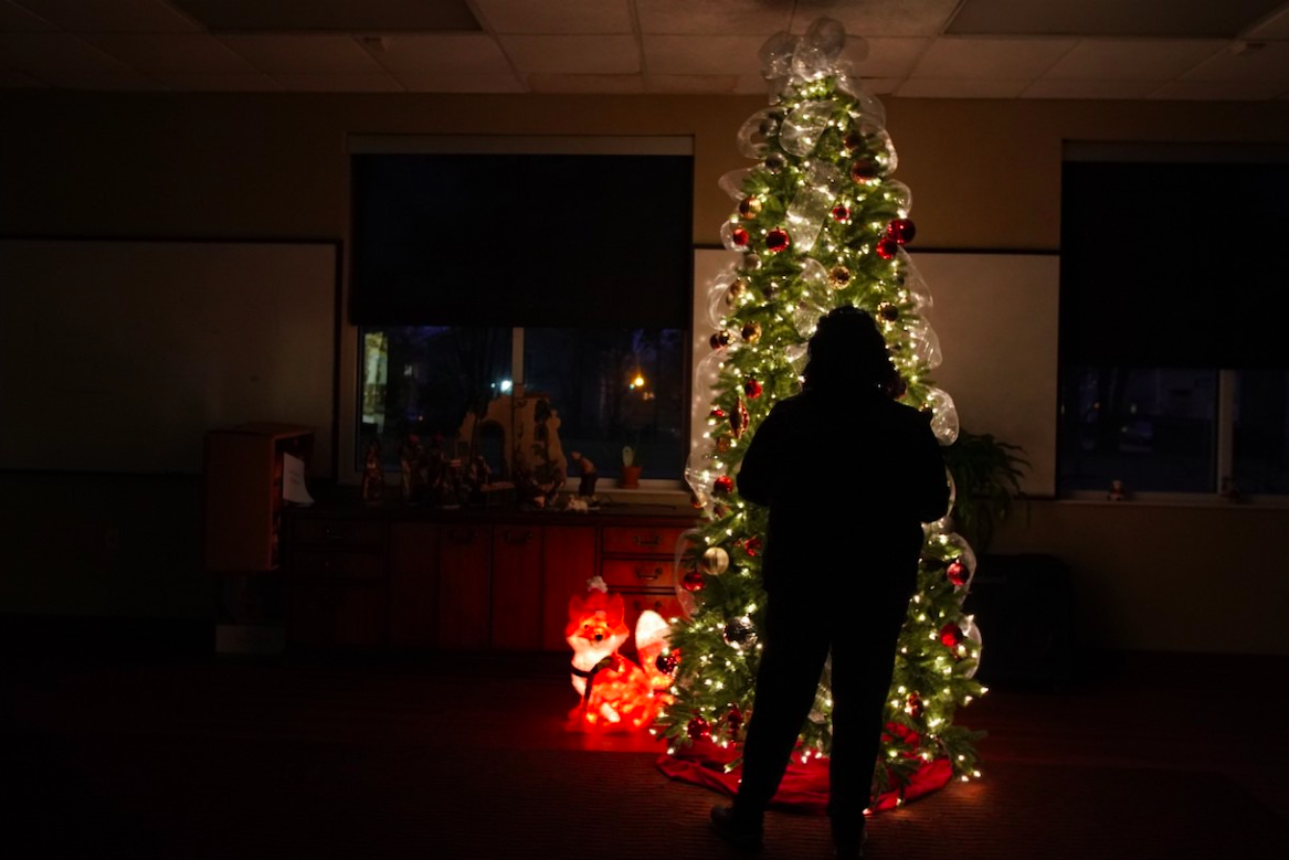 A Memphis victim of domestic violence stands in the glow of a Christmas tree in a Mid-South shelter. She escaped her abuser but is isolated from family over the holidays. Severe cases of domestic violence are on the rise during the pandemic. Image by Karen Pulfer Focht/Special to Daily Memphian. United States, 2020. A Memphis victim of domestic violence stands in the glow of a Christmas tree in a Mid-South shelter. She escaped her abuser but is isolated from family over the holidays. Severe cases of domestic violence are on the rise during the pandemic. Image by Karen Pulfer Focht/Special to Daily Memphian. United States, 2020.