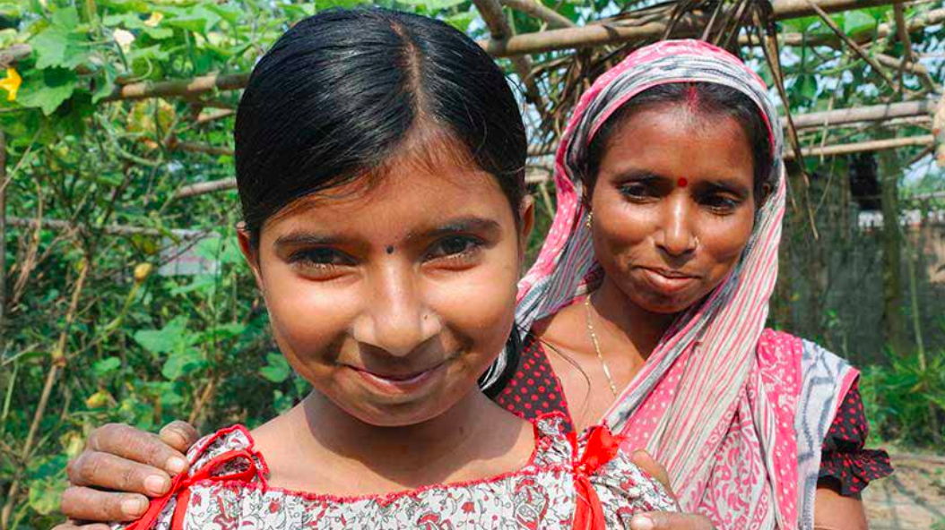 Suchitra Dey with her daughter, Tulsi (left), after Dey received rights to her plot of land in West Bengal. Image courtesy Landesa. India. Suchitra Dey with her daughter, Tulsi (left), after Dey received rights to her plot of land in West Bengal. Image courtesy Landesa. India.