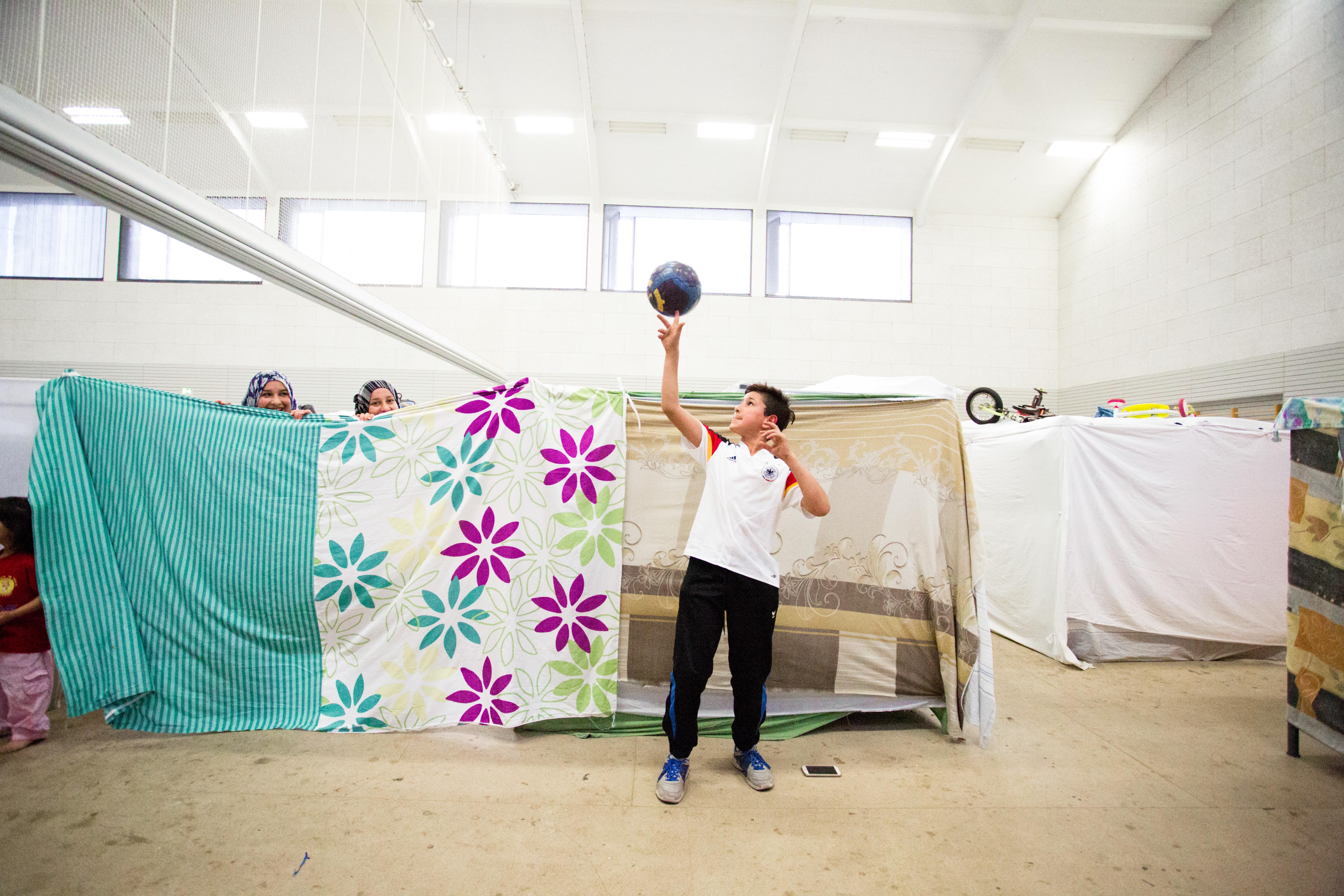 Abdullah, 12, lives in a crowded converted gym outside Berlin that houses refugees. Image by Emily Kassie. Germany, 2016. Abdullah, 12, lives in a crowded converted gym outside Berlin that houses refugees. Image by Emily Kassie. Germany, 2016.