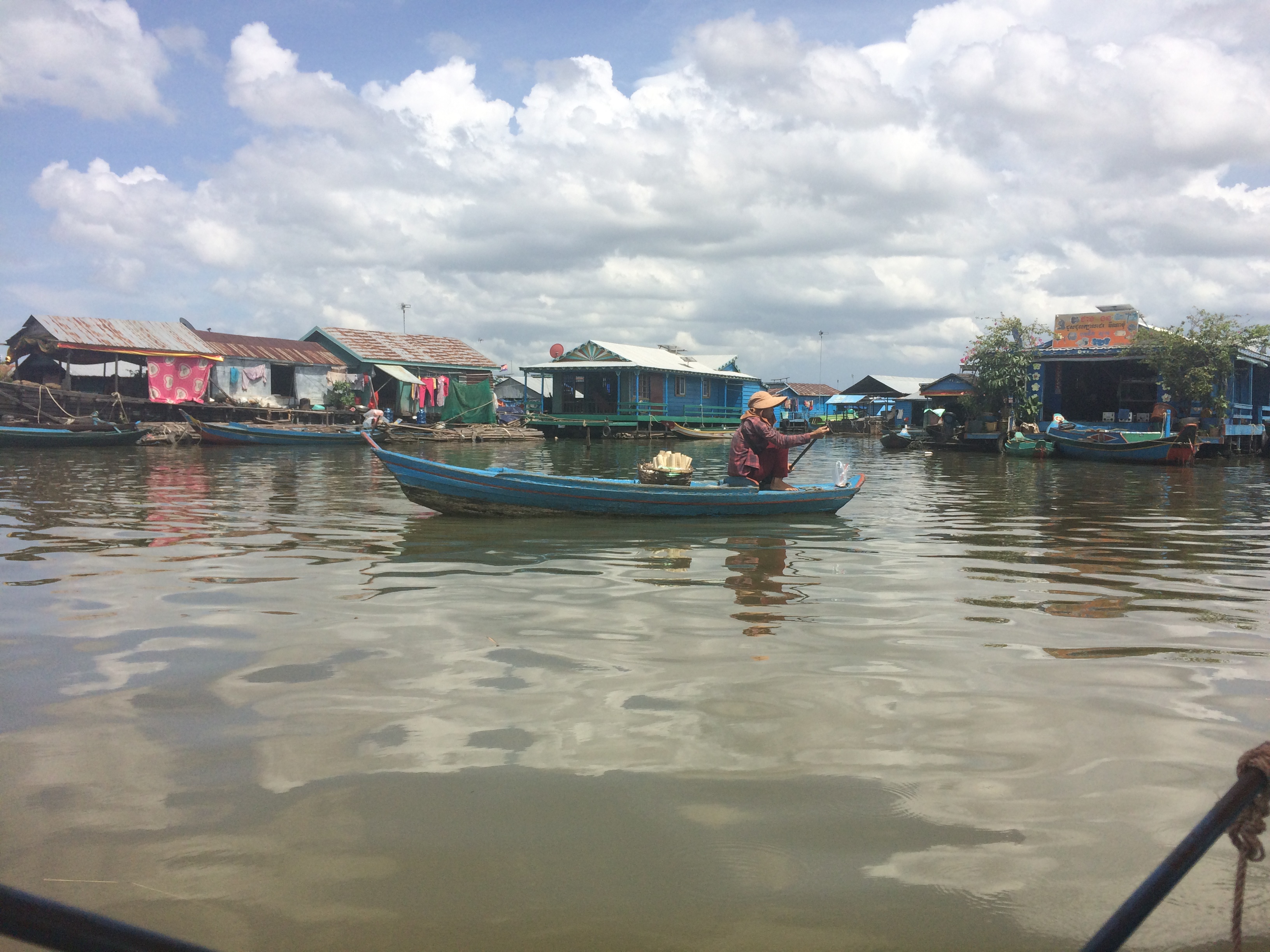 An ethnic Vientamese food vendor paddles through a floating village on Tonlé Sap Lake. Image by Ben Mauk. Cambodia, 2017. An ethnic Vientamese food vendor paddles through a floating village on Tonlé Sap Lake. Image by Ben Mauk. Cambodia, 2017.