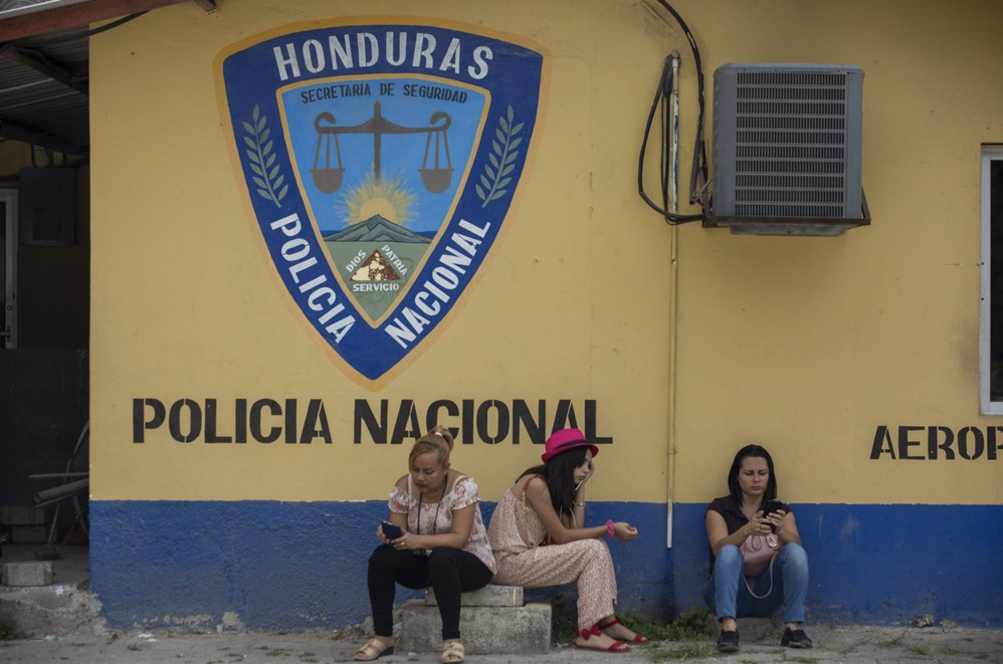 Family members wait outside the Ramon Villeda International Airport in La Lima, Honduras on Nov. 29, 2019, for the arrival of their relatives who were deported from the United States. Immigration apprehensions along the U.S.-Mexico border have plunged by more than 70 percent in the past six months, down sharply from at least 132,000 in May. Image by Moises Castillo/ AP Photo. Honduras, 2019. Family members wait outside the Ramon Villeda International Airport in La Lima, Honduras on Nov. 29, 2019, for the arrival of their relatives who were deported from the United States. Immigration apprehensions along the U.S.-Mexico border have plunged by more than 70 percent in the past six months, down sharply from at least 132,000 in May. Image by Moises Castillo/ AP Photo. Honduras, 2019.