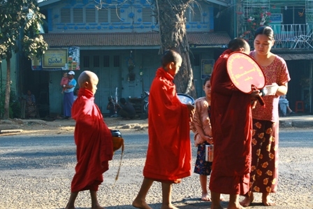 Every day at dawn, monks walk the streets on alms round. Townspeople say there are fewer monks than before, as many fled back to their home villages after the government crackdown on September's protests. In deeply religious Burma, monks depend on the ability of the laypeople to provide for them. 1