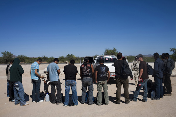 A group of migrants are stopped and searched by the Mexican army near Sasabe, Sonora. 1