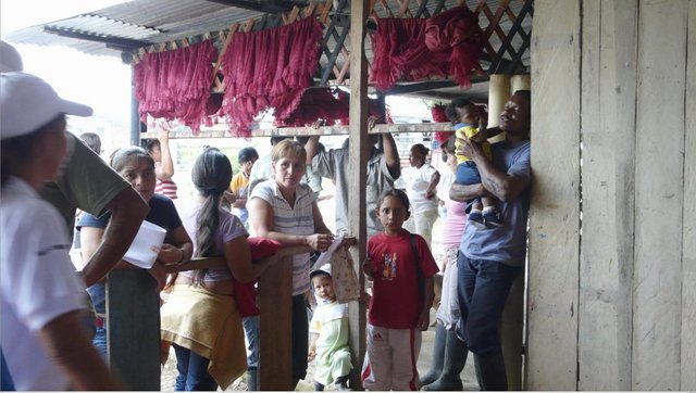 Colombian refugees wait for aid in the tiny border town of Puerto Nuevo, Ecuador, after fleeing their country to escape a drug-fueled civil war. The Ecuadorean military fears Colombian rebels are also streaming in, using the refugees as cover. Image by Kelly Hearn. Ecuador, 2008.
