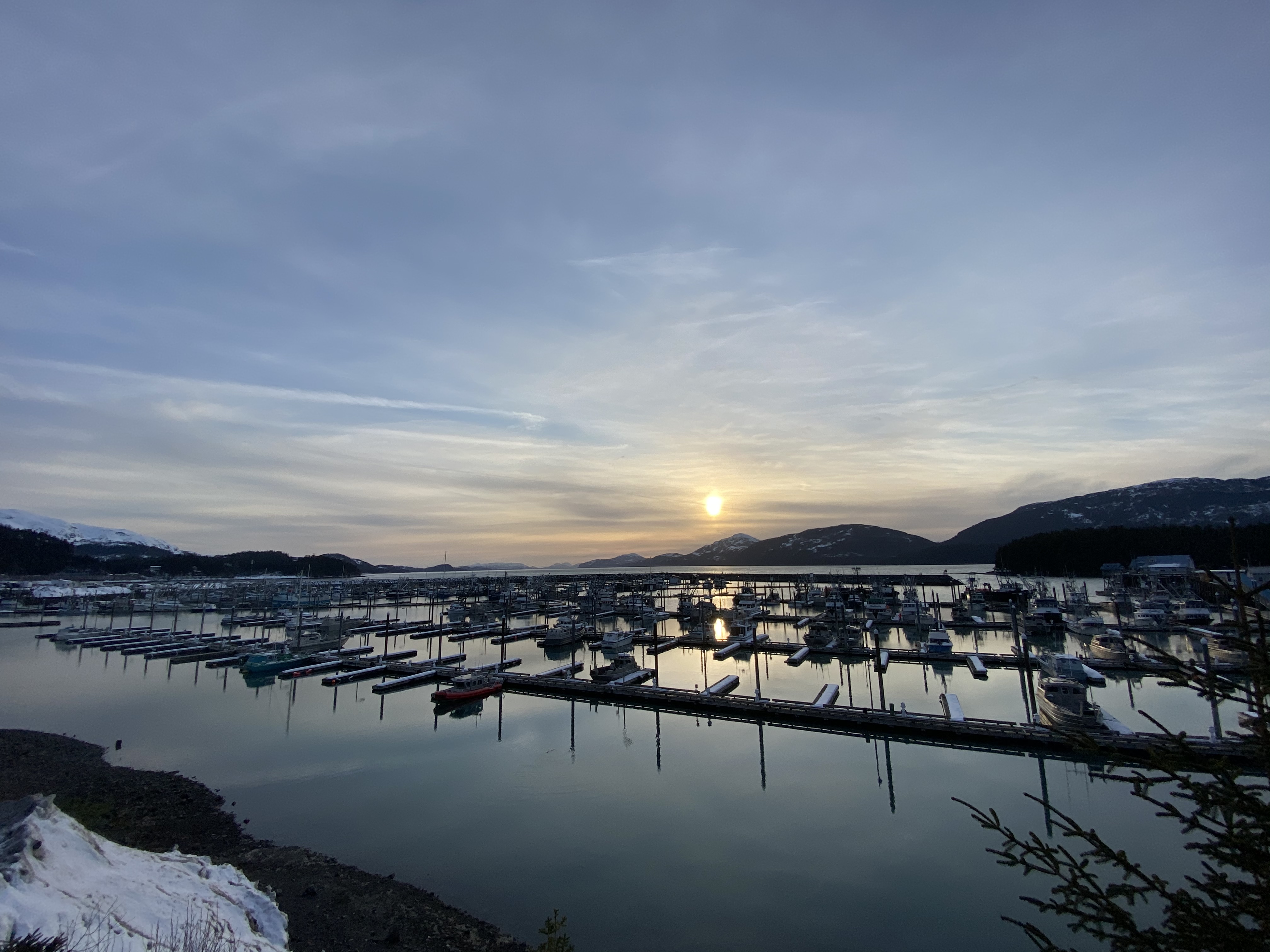 A harbor with mountains in background.