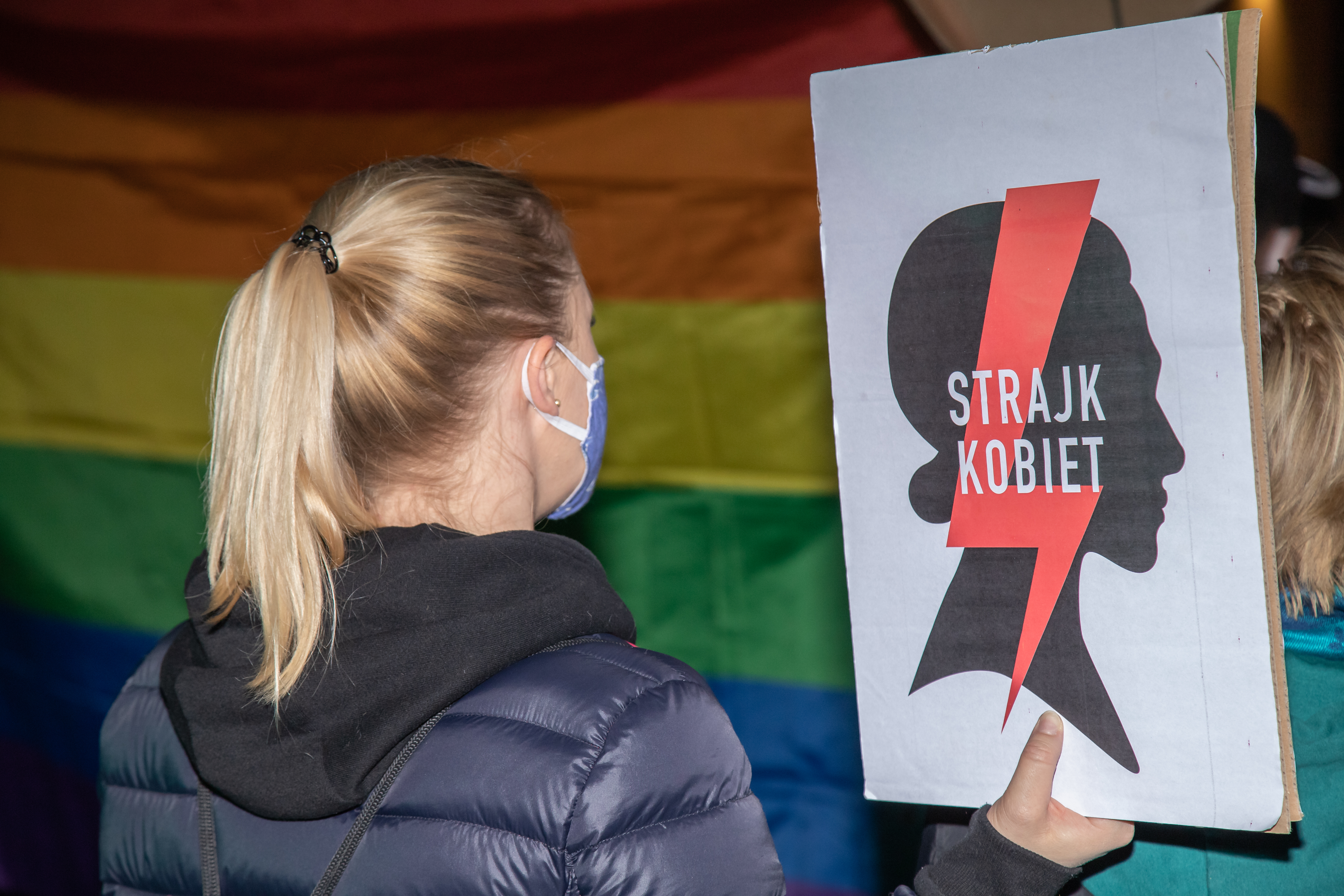 A demonstrator holds a sign reading "Women's Strike" in Polish during an abortion rights protest.