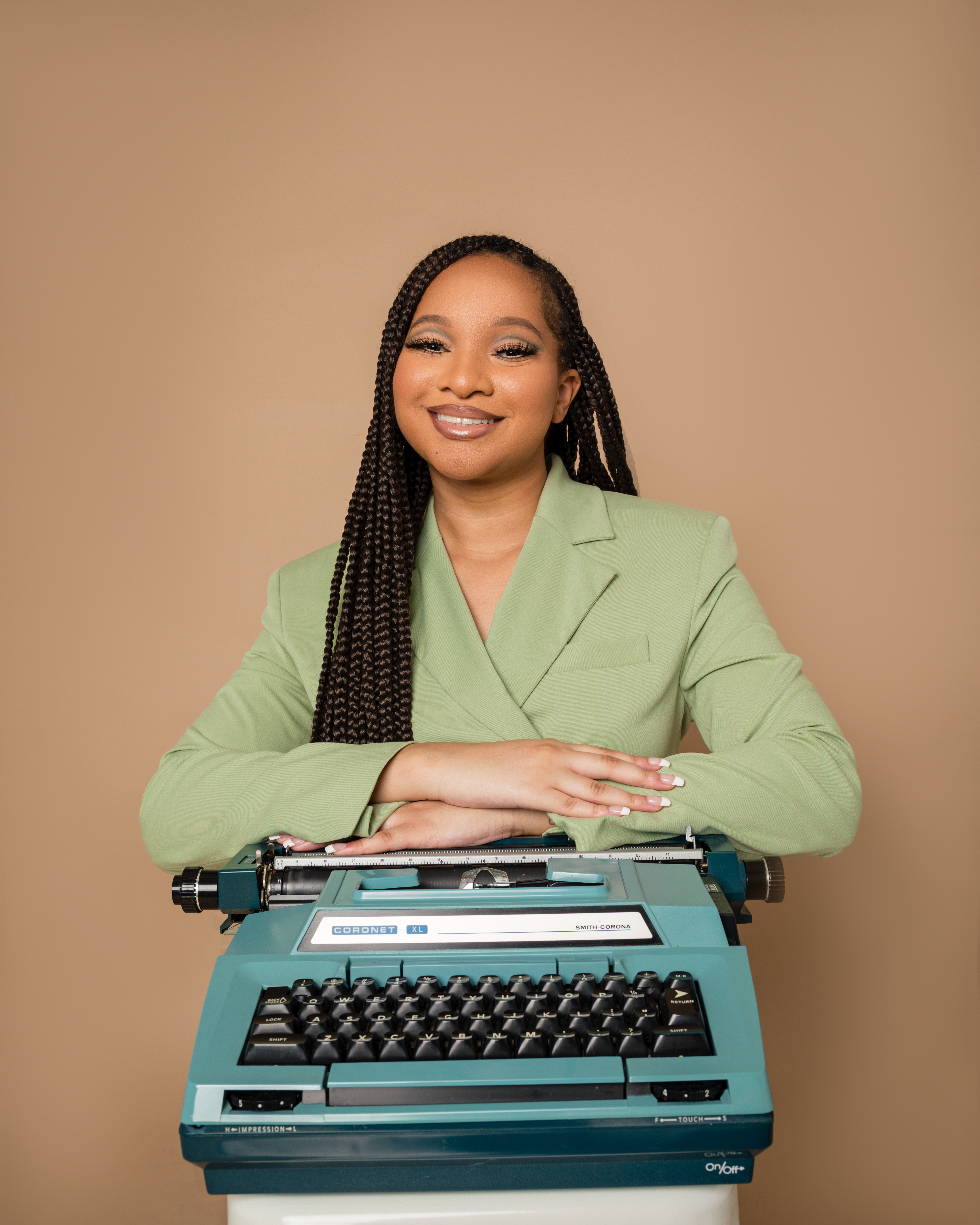 Alexis McGowan poses with an electric typewriter