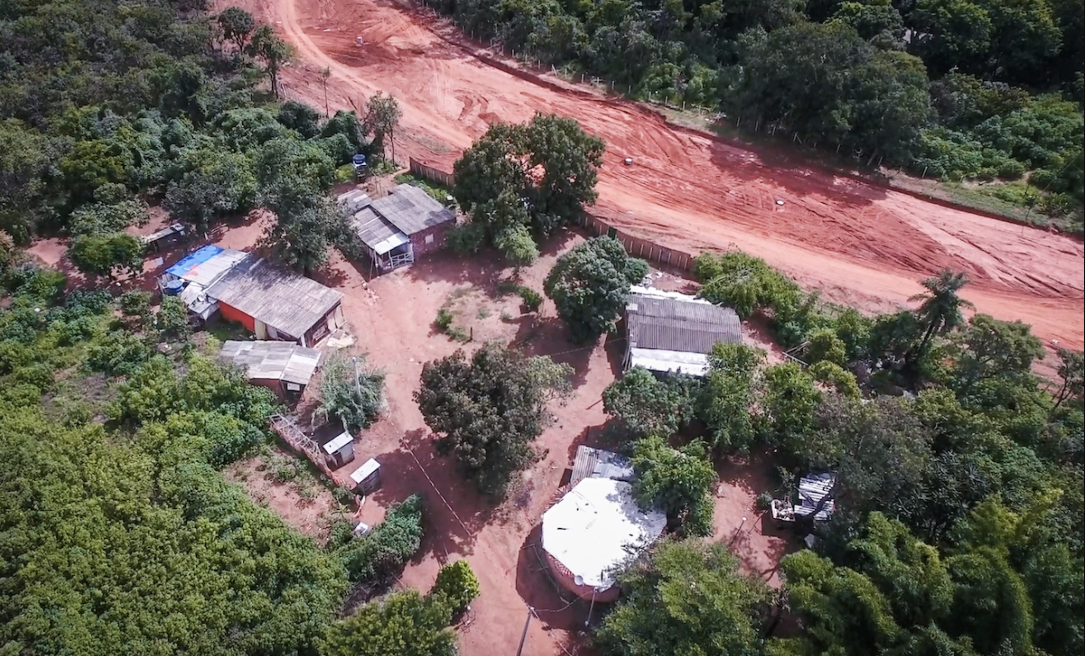 Screen Shot 2021-05-25 at 5.26.51 PM.png Aerial view of buildings in a forested area.