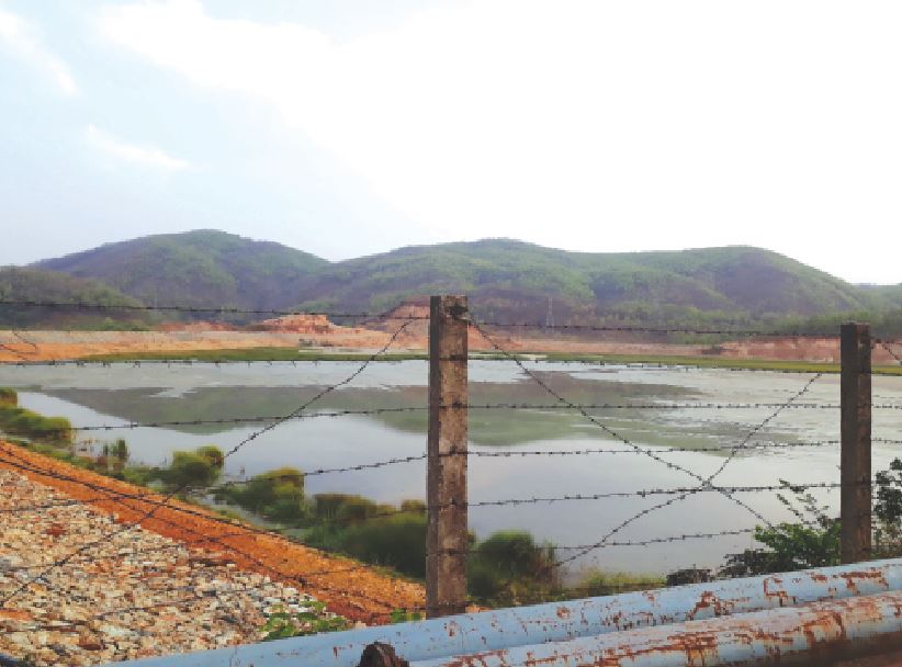 43-1.jpeg Image of a pond behind a fence.