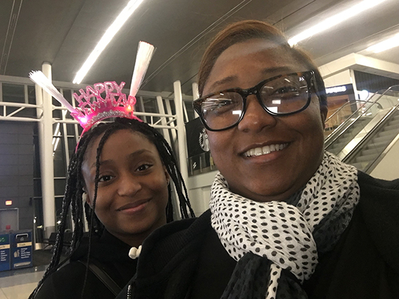 Saichelle_McNeill.jpeg A photo of Saichelle McNeill and her daughter J’Nai. J'Nai wears a "Happy New Year" headband.