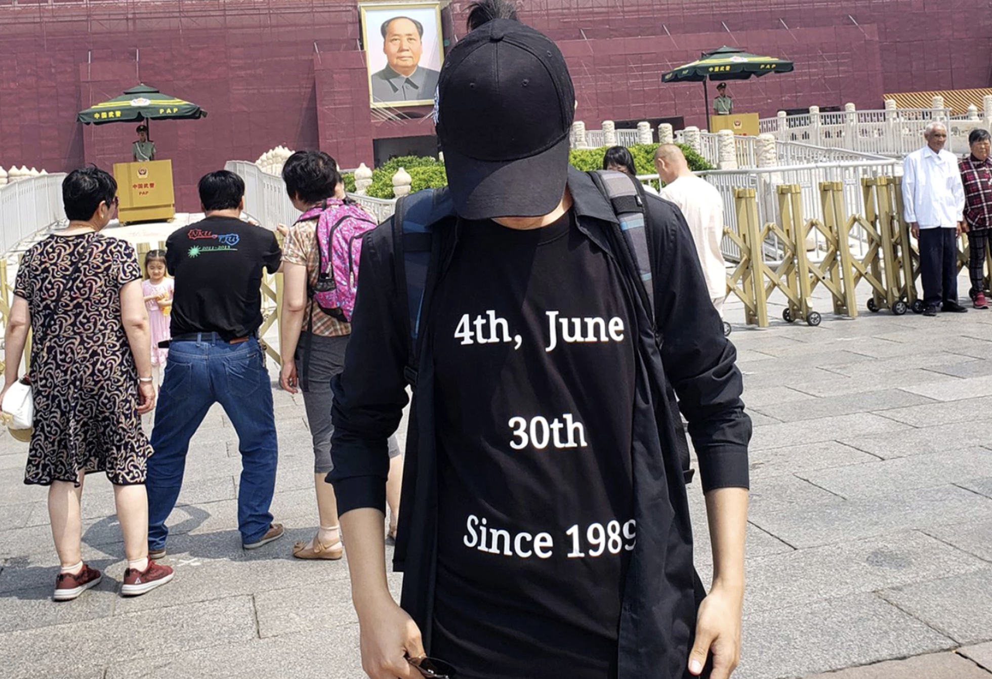 Screen Shot 2021-06-25 at 9.40.24 AM_0.png man stands in black shirt that reads 4th June 30th since 1989 in front of forbidden city