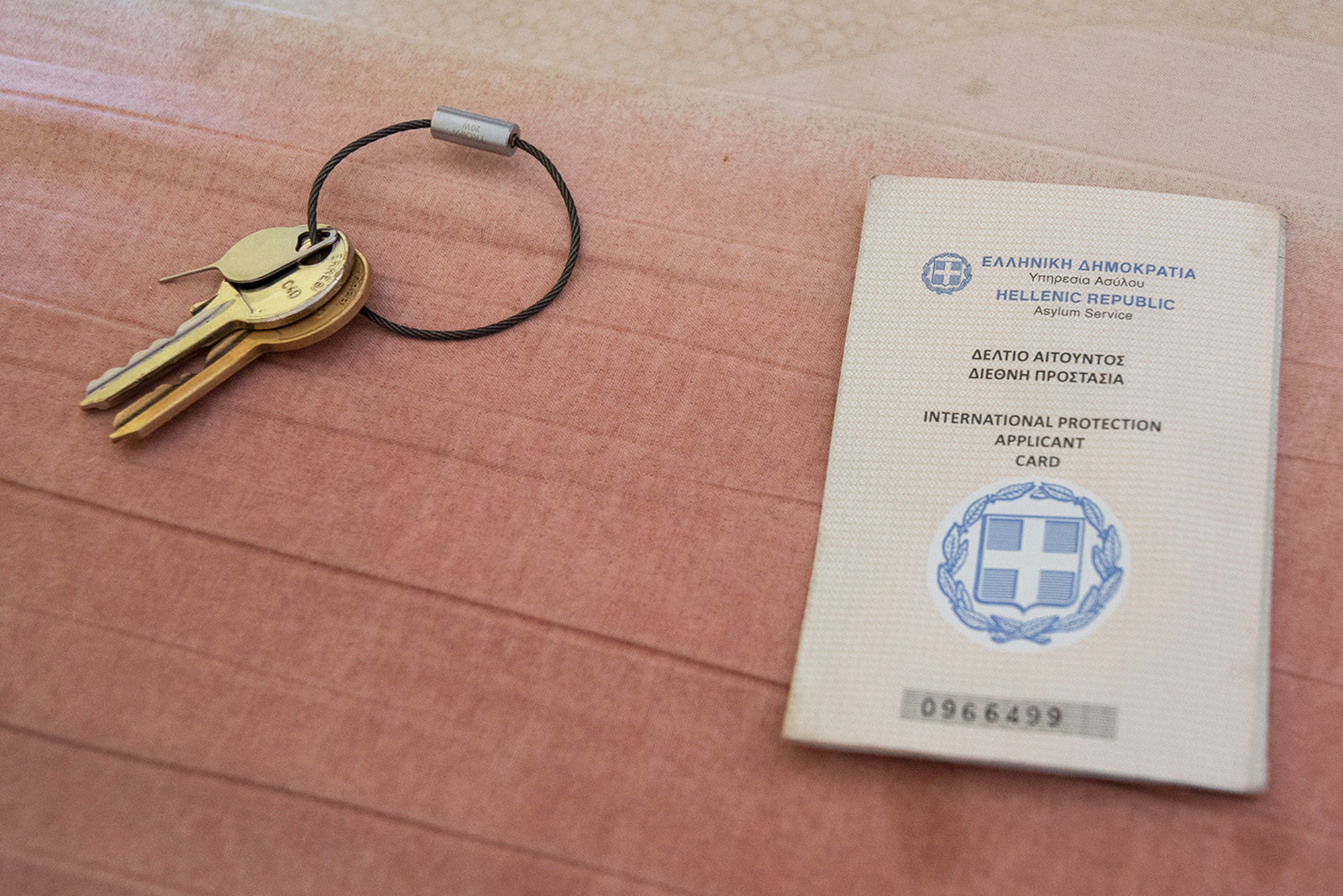 A card given to migrants when they've applied for asylum and a pair of keys