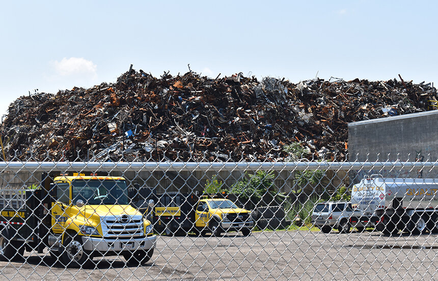 photo of truck in front of trash plant