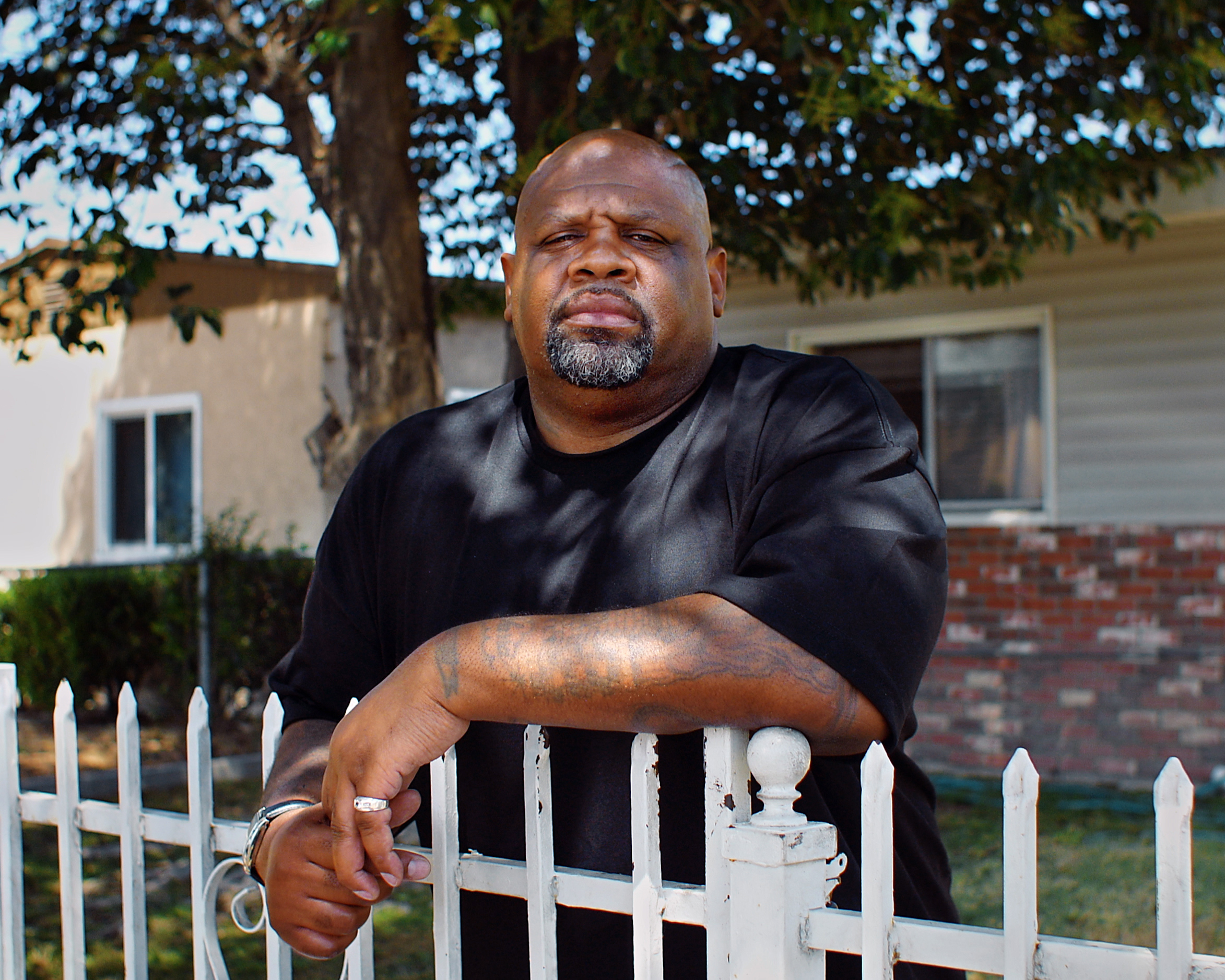 Melvin Smith stands outside his childhood home in Compton, California.