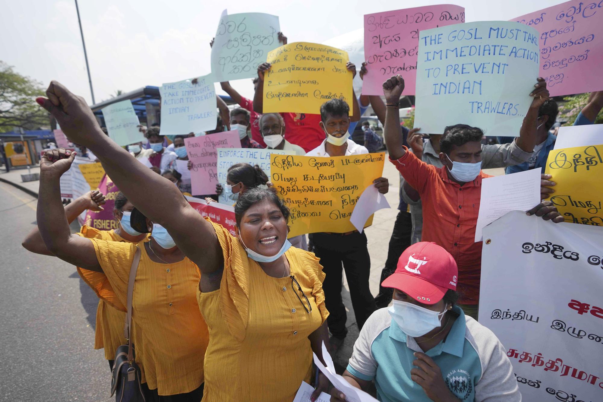 Women hold signs