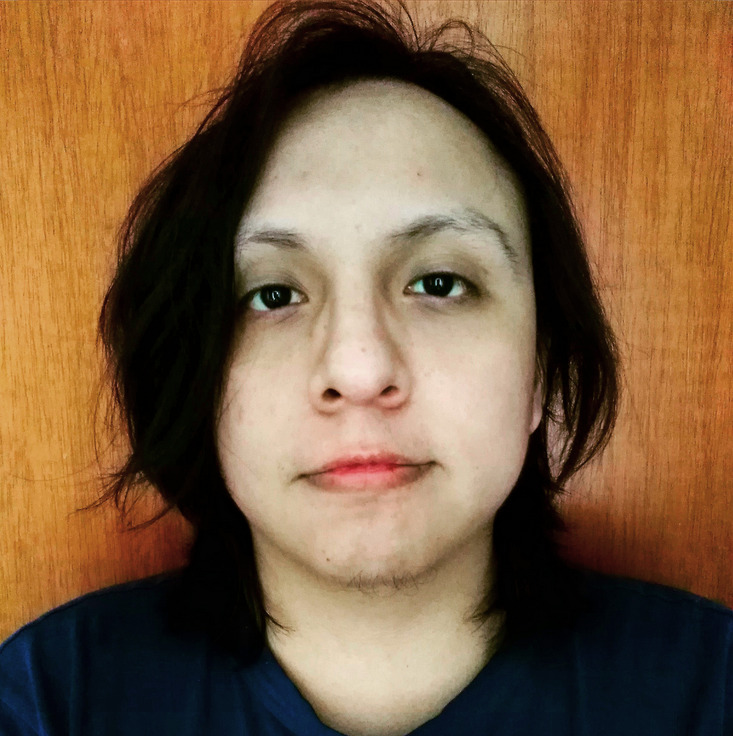A person with black long hair and a black shirt.