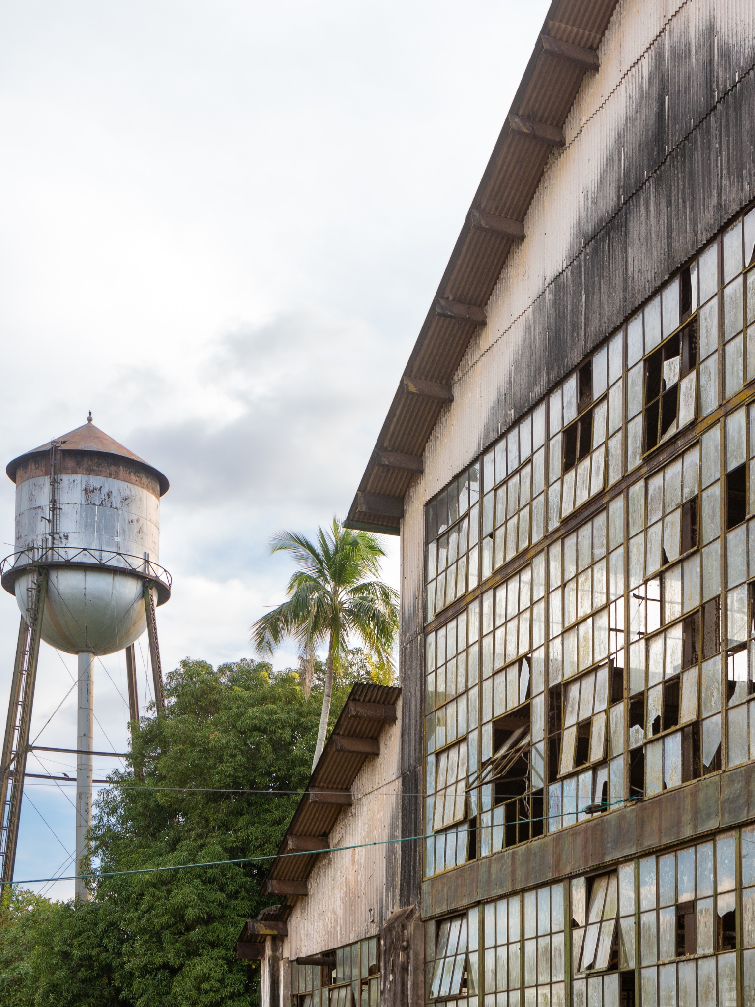A water tower is right next to a warehouse in Brazil.