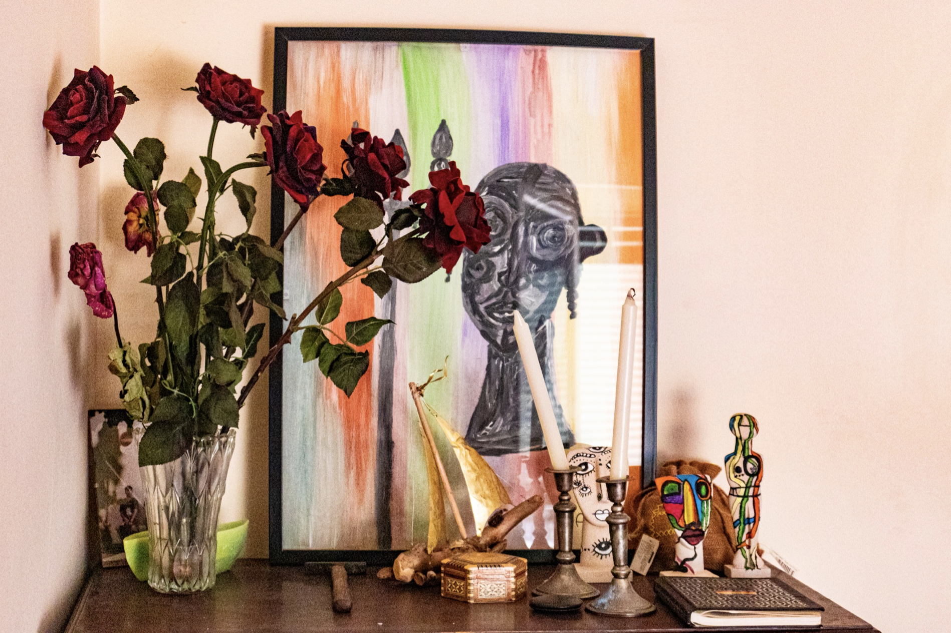 roses and artwork on table