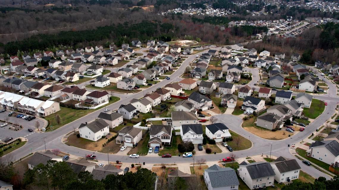 Aerial view of a neighborhood with large, two story houses.