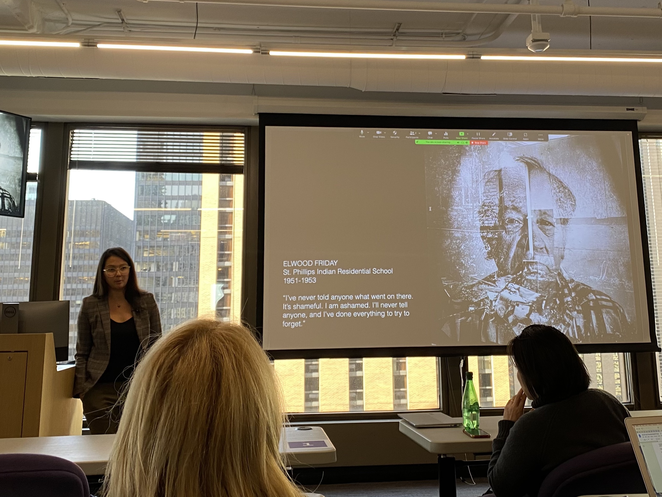 Zalcman.jpg Zalcman stands next to presentation screen with work on Indigenous communities.