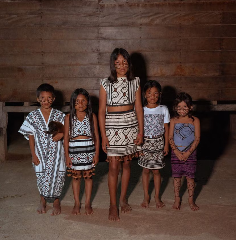Children from the isolated tribes stand together dressed in their traditional outfits.