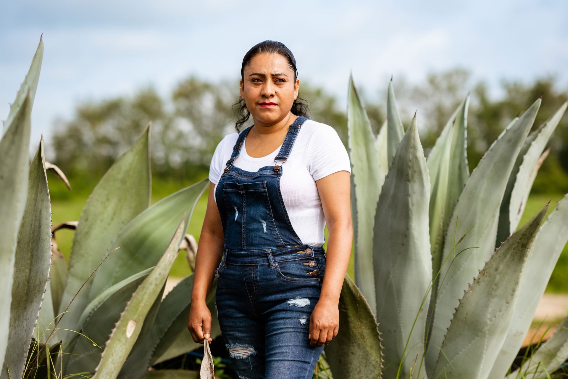 a woman worker stands in front of desert landscape
