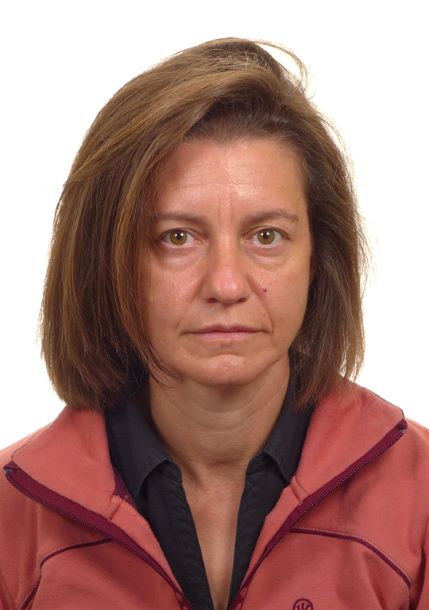 Woman with medium length brown hear wearing a red jacket