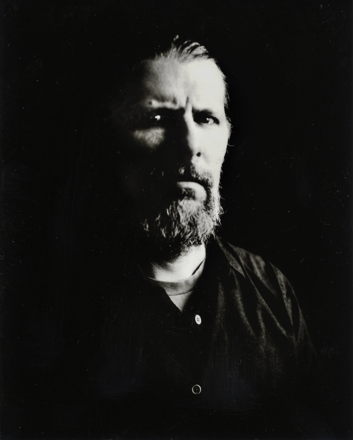 Black and white image of a headshot of a man