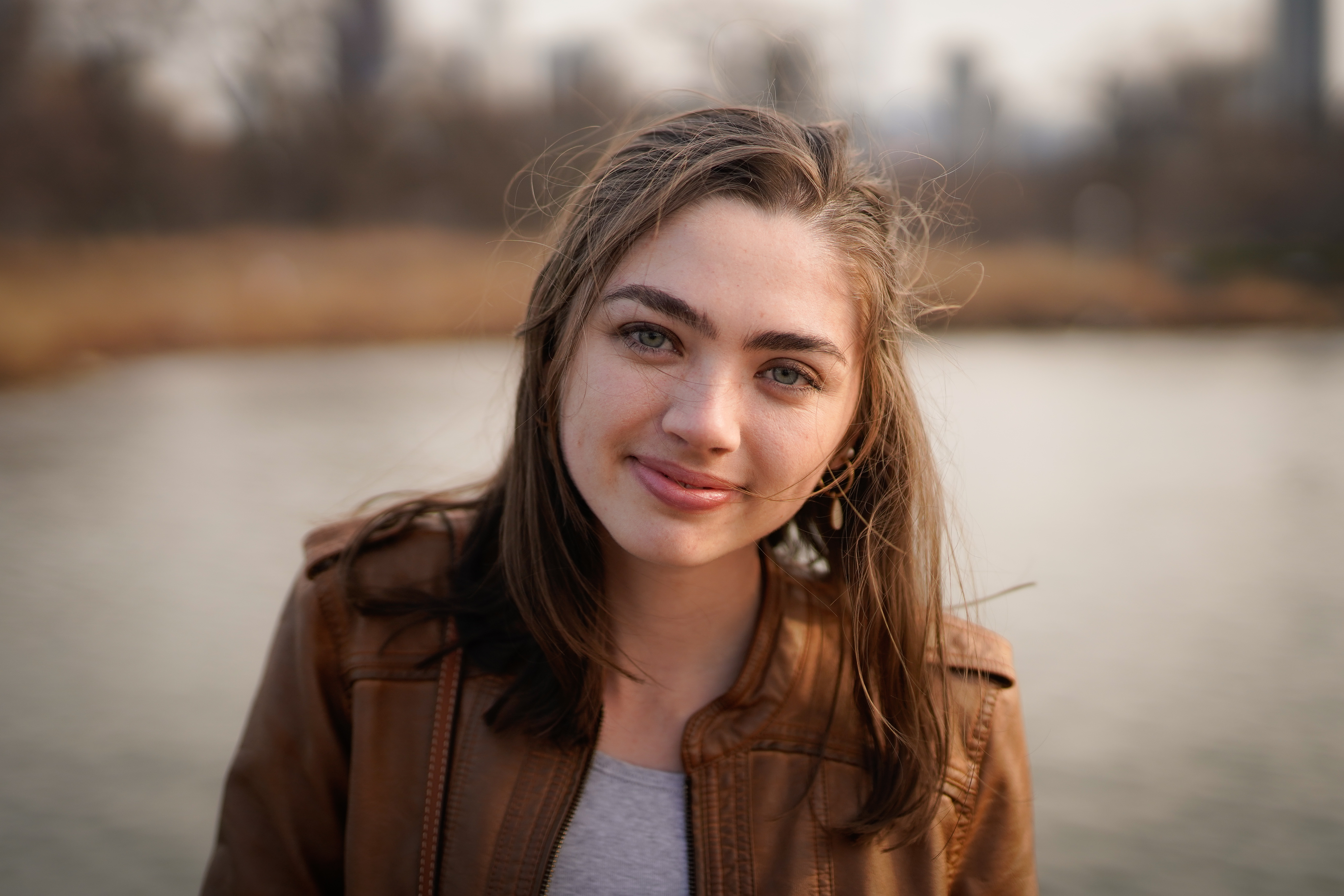 Woman with long brown hair smiles at the camera