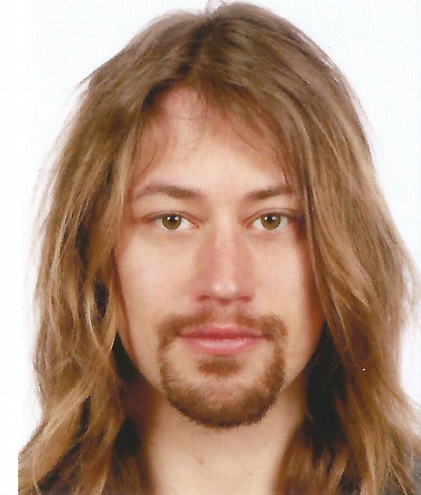 A man with long light-colored hair and facial hair