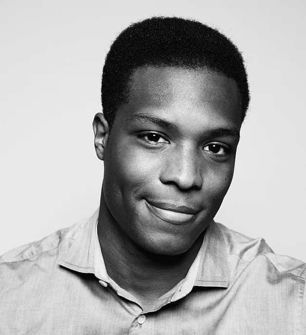 Headshot of Josiah Bates wearing a light button down shirt