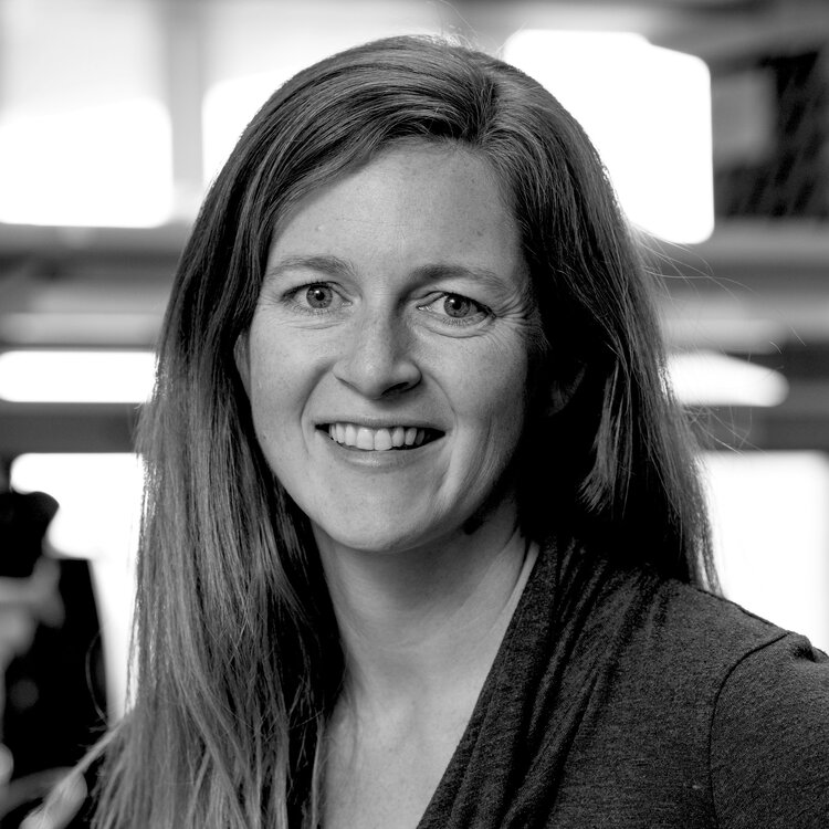 Black and white headshot of a woman with long hair