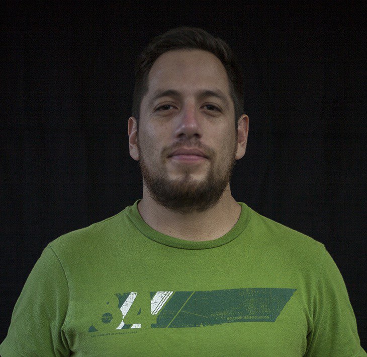 Headshot of a man wearing a green shirt