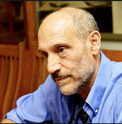 A man wearing a blue button down