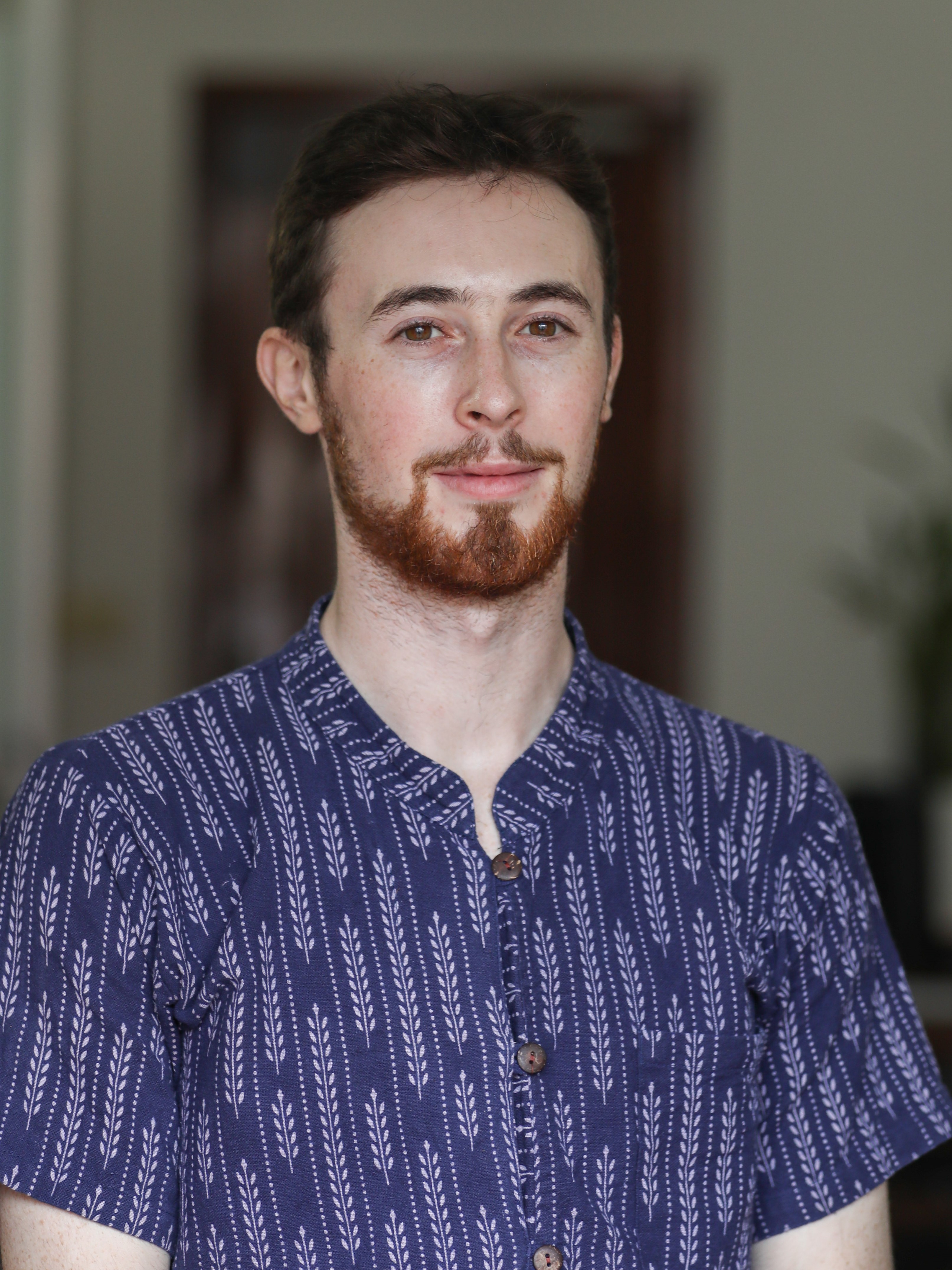A close-up shot of Jack in a printed blue shirt.